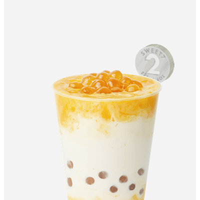 7分甜新創(chuàng)新水果奶茶，芒果果肉加入香濃牛奶，
配上清香白桃烏龍茶，Q彈珍珠增加咀嚼口感，唇齒意猶未盡